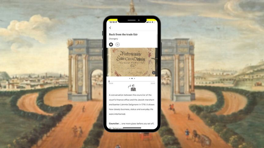 Smartphone with Diverse Voices station in front of a painting in the knights’ hall at Weikersheim Palace showing carriages in a landscape